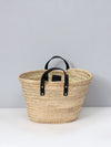 Basket bag with short black leather handles.