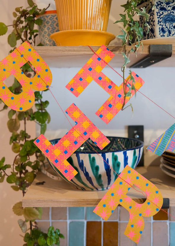 Happy Birthday banner hanging in a colourful kitchen