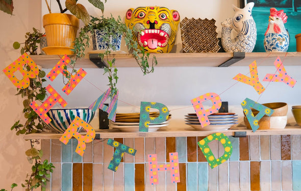 Happy Birthday banner hanging in a colourful kitchen
