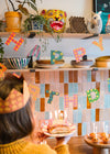 Happy Birthday banner hanging in a colourful kitchen