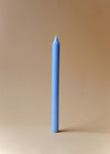 A tall light blue dinner candle.