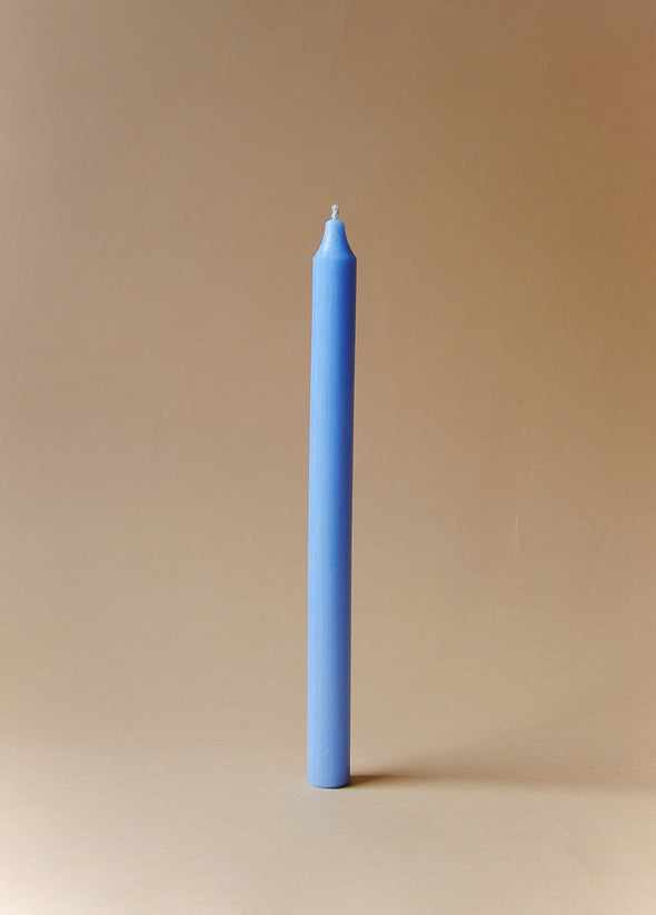 A tall light blue dinner candle.