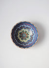 Ceramic bowl decorated in traditional Romanian pattern. Blue base with swirls of white, red, yellow, green and brown.