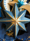 Blue and gold star-shaped decoration with intricate patterns