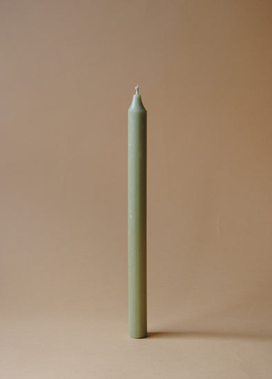 A tall green dinner candle.