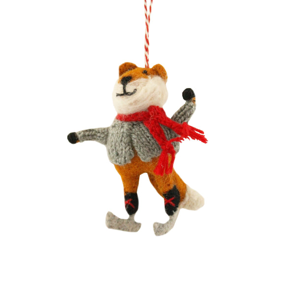 Felted fox ornament with a red scarf and wearing skates, on a white background