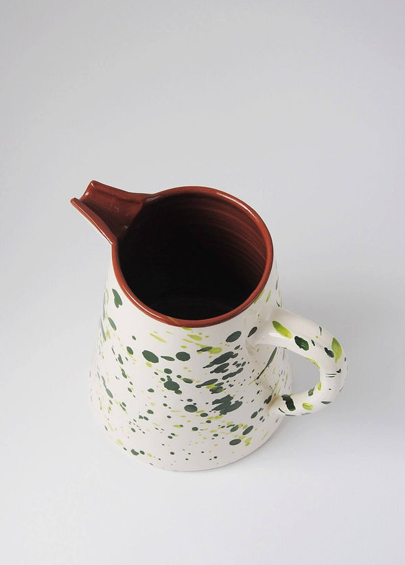 Ceramic large jug. White glaze with green splatter pattern on exterior, terracotta glaze on interior.