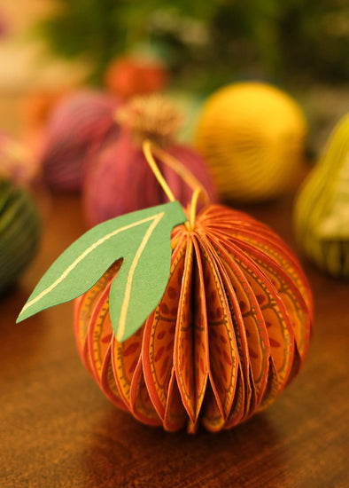 Paper honeycomb decoration in the shape of an orange.