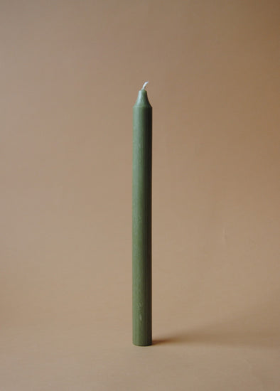 A tall green dinner candle.