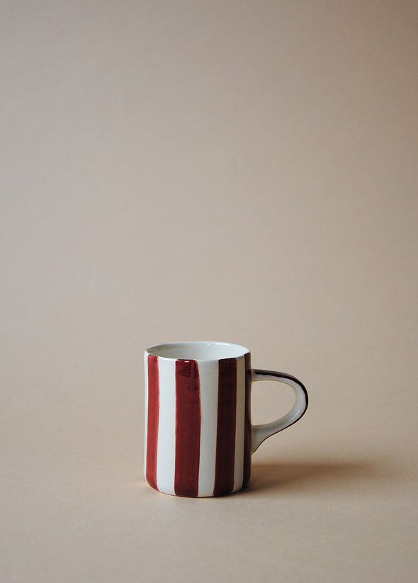 Burgundy and white striped ceramic espresso cup.