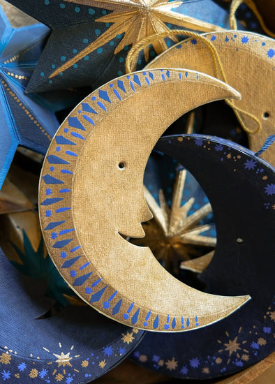 Decorative moon and star shapes with intricate patterns in gold and blue.