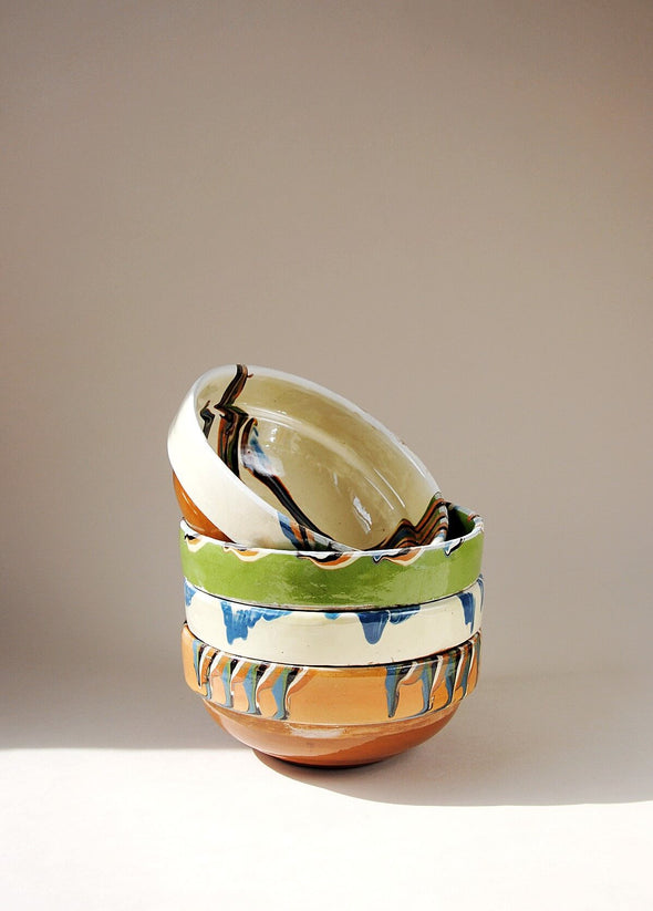 Stack of ceramic bowls decorated in traditional Romanian pattern. 