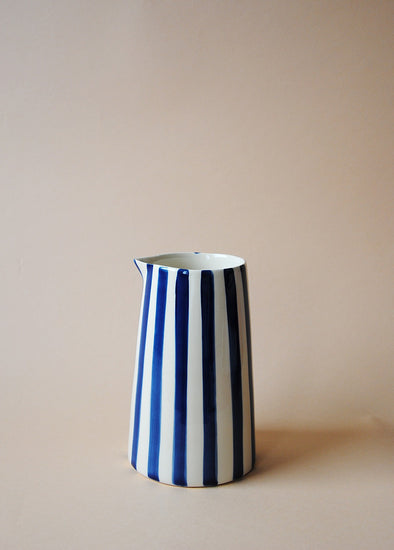 Blue and white striped ceramic jug.