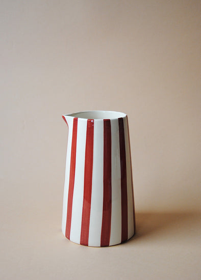 Burgundy and white striped ceramic jug.