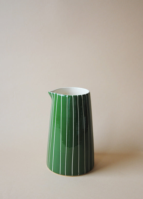 Green and white striped ceramic jug.