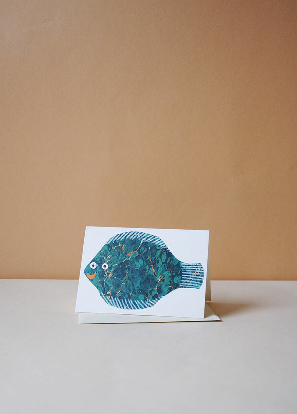 Greetings card with a fish design. The fish is blue and turquoise with a red smiling mouth.