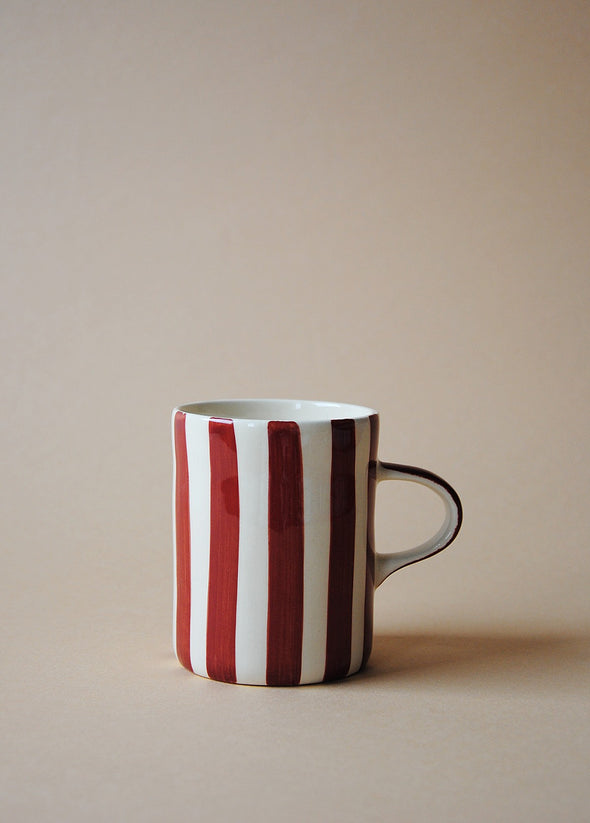 White ceramic mug with painted burgundy stripes.