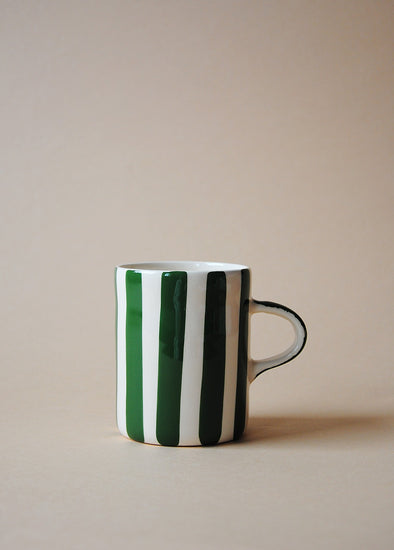 White ceramic mug with dark green painted stripes.