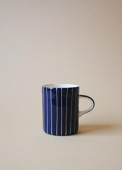 Blue and white striped ceramic mug.