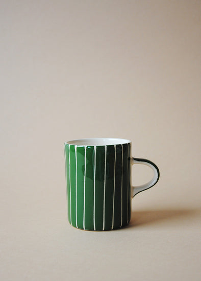 Green and white striped ceramic mug.