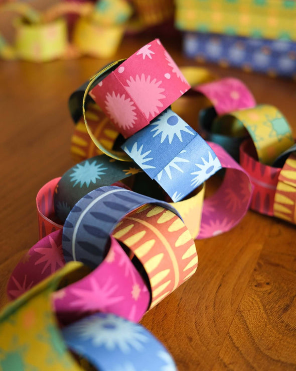 Multicoloured paper chain in red, pink, blue, yellow and green.