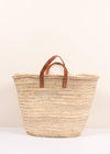 Basket bag with short tan leather handles.