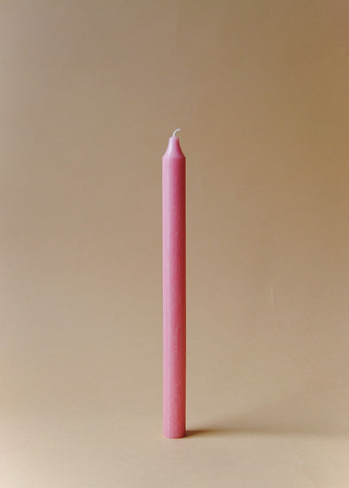 A tall pink dinner candle.