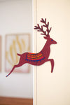 A paper garland featuring brown reindeer sewn on cotton string. 