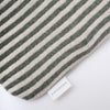 Close up of knitted lambswool hot water bottle with vertical stripes in green and white. Height thirty four centimetres, width twenty centimetres.