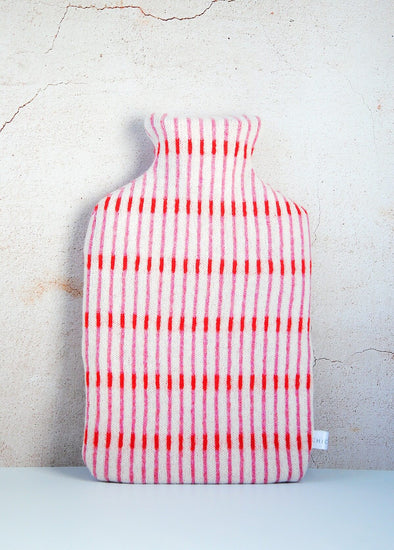 White knitted lambswool hot water bottle with thin vertical stripes in red and pink. Height thirty four centimetres, width twenty centimetres.