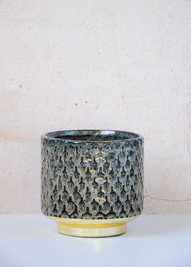 A handcrafted ceramic planter featuring a blue glaze on the body and gold on the base. Height of ten centimetres and width of ten centimetres.