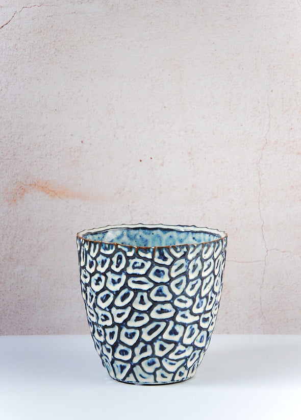 Ideal for small houseplants, this eye catching stoneware planter has a tactile design featuring a pattern glazed in blue, cream and brown. Height thirteen point five centimetres, Width fourteen centimetres.