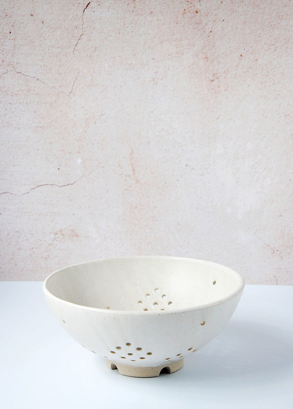 Ceramic berry bowl in a white glaze. The bowl is 9.5cm high and 21.3cm wide at the top.