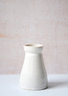 Small pourer handmade by Dor and Tan using local Cornish clay. It has a white glaze and is thirteen point five centimetres tall and six centimetres wide at the top opening. It has a capacity of six hundred and fifty millilitres.