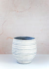 Striped stoneware planter with a grey base and white crackle glaze stripes. Height nineteen centimetres and width twenty centimetres.