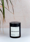 Scented candle in a brown apothecary inspired jar, made by Earl of East London using only natural soy wax. The label shows the name as being Jardin de la Lune. The jar has a capacity of one hundred and seventy millilitres and is eight centimetres tall and six point five centimetres wide.