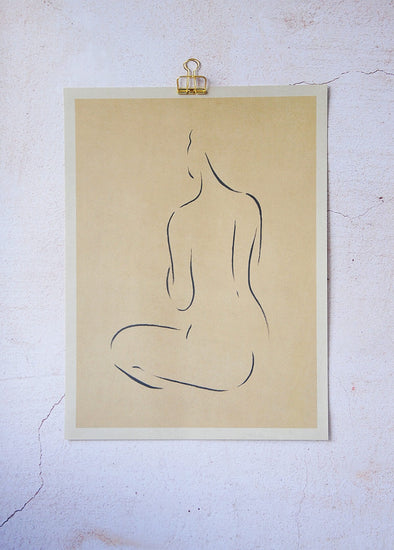 Figure line painting of a woman kneeling and facing away by design studio Lemon. Black on beige paper. Height forty centimetres, width thirty centimetres.