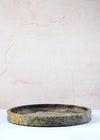 Round tray made from one hundred percent green marble. Thirty centimetres wide and the edges are four centimetres high.