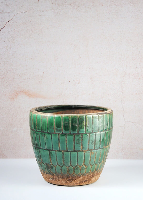Featuring a geometric design, this planter is made from terracotta with a lovely deep jewel green glaze. Height thirteen centimetres, Width fifteen centimetres.
