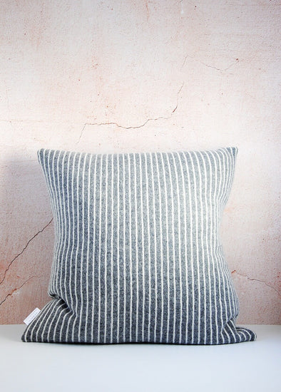  Dark grey knitted lambswool cushion with thin white vertical stripes. Height forty five centimetres, width forty five centimetres.