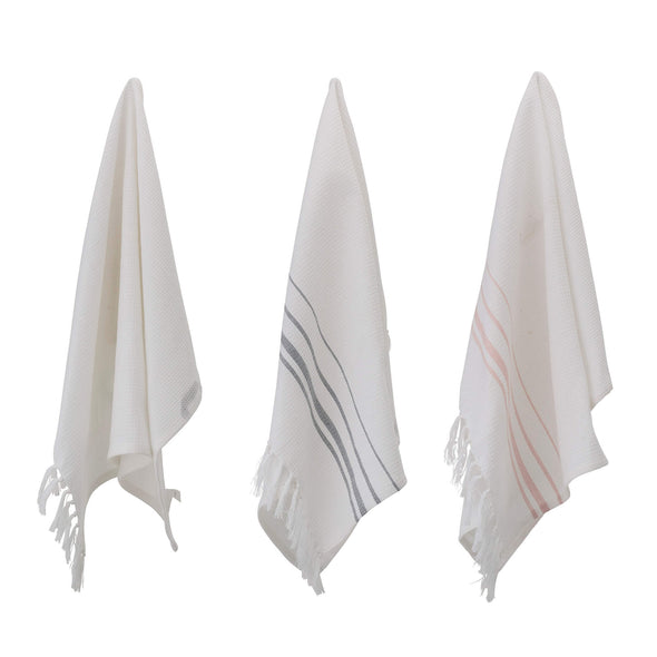 Set of three kitchen towels displayed hanging . All are white, one is plain, one has rose stripes and one blue/grey stripes. They have a waffle texture and tassels. Length seventy centimetres, width fifty centimetres.