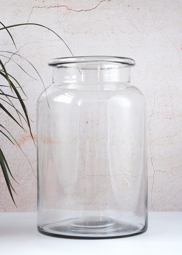 Large clear glass jar vase, mouth blown and purely handcrafted. Can be used to display flowers or for storage. Twenty-eight centimetres tall and eighteen centimetres wide.