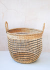 Open weave seagrass basket in natural and black with handles. Height twenty eight centimetres, width thirty five centimetres.