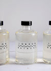 Close up of three glass bottles of foam bath by London Bathers.