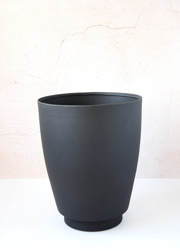 Black metal planter. It is 25cm tall and 21cm wide