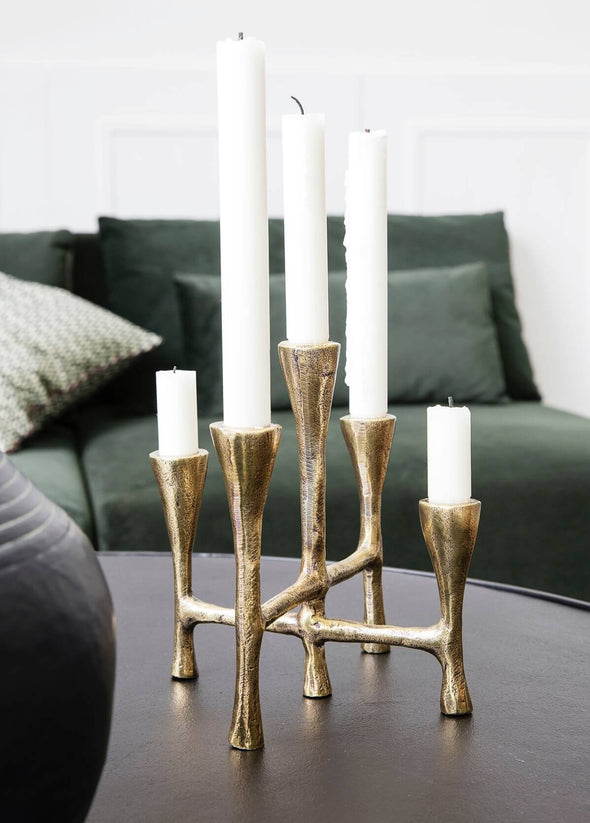 Metal candle stand that is able to display five candles at the same time. Made from aluminium with a brass finish, it is suitable for candles measuring four centimetres in diameter. Twenty centimetres tall, nineteen centimetres across and twenty centimetres in length.