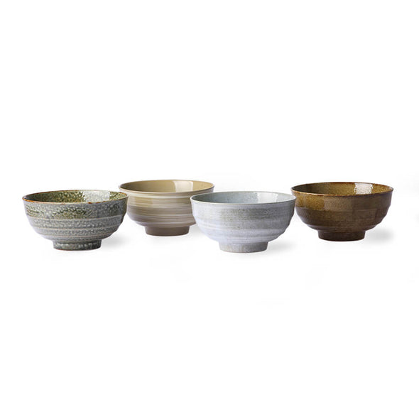 Four ceramic noodle bowls. One is green, one beige, one white and the last brown.