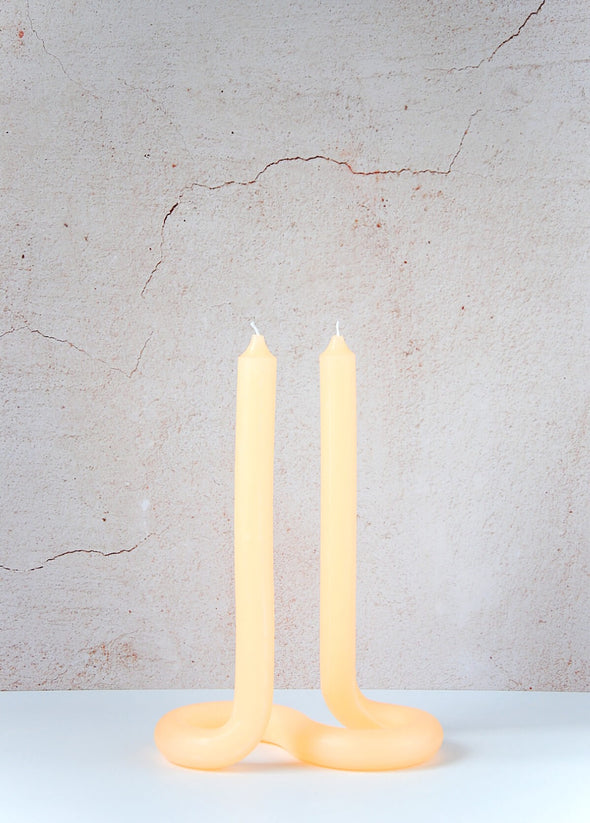 Handmade candle by Dutch designer Lex Pott. Double ended twist candle in peach made entirely from wax and formed in such a way it stands alone on a twisted s shape base. Height twenty four centimetres, width ten centimetres, length seventeen point five centimetres.