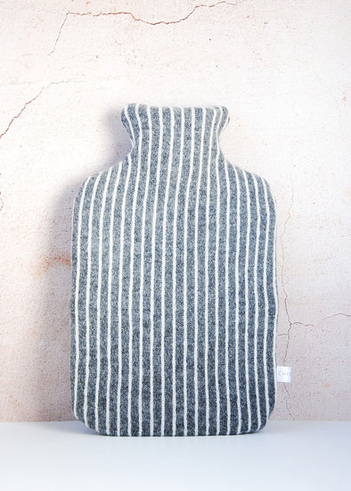 Dark grey knitted lambswool hot water bottle with vertical thin white stripes. Height thirty four centimetres, width twenty centimetres.