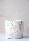 Terrazzo planter handmade by Salt Studios. Featuring a white base with pink and green terrazzo detail. Twelve centimetres tall and twelve centimetres wide.